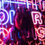 Girl with Reflection of Pink and Blue Neon Signs